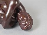 a figurine of a woman laying down on a table
