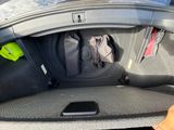 a suitcase in the trunk of a car with luggage in it