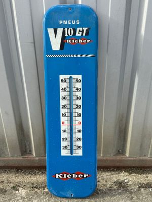 a blue thermometer that is on the ground