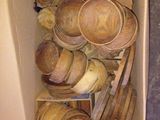 a cardboard box filled with wooden bowls and spoons