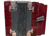 an old red accordion with a black case on it