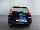 the rear end of a black car in a white room
