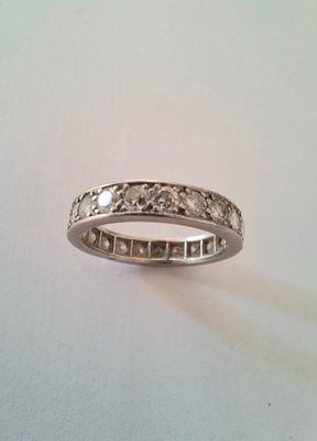 a close up of a ring on a table with a white background