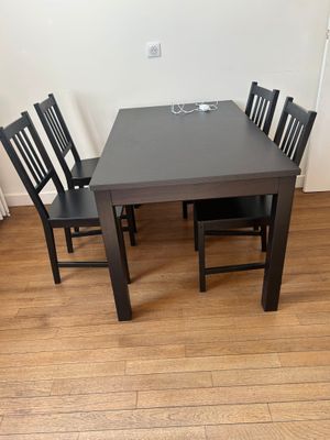 a black table and four chairs in a room