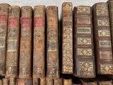many old books lined up on a shelf