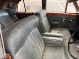an old car with leather seats in the back of it