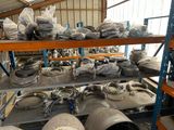 many different types of pipes on a shelf in a warehouse