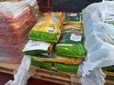 many bags of food on a pallet in the store