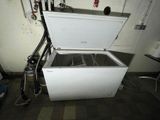 a white chest freezer sitting in a room