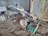 un petit tracteur qui est à l'arrêt dans la terre