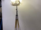 a lamp that is on a tripod in a room