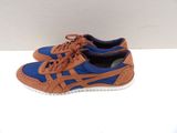 pair of blue and brown athletic shoes on a white surface