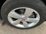 the tire of a car is shown with a red emblem on it