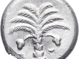 a silver coin with a palm tree on it