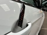 a sticker on the door handle of a white car