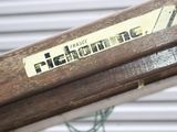 a close up of a wooden bench with a sticker on it