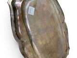 an image of a silver plate with an oval design on it