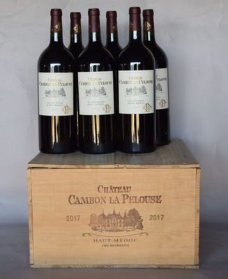 six bottles of wine are in a wooden box on a table