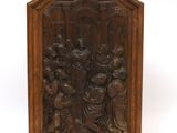 an old wooden plaque with an image of a group of people on it