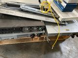 a pile of electronics on a table in a warehouse