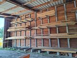 many pieces of wood stacked on the shelves in the building