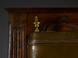 a clock sitting on top of a wooden cabinet