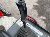 a close up of a red and black car with a gear stick