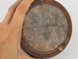 a hand that is holding a plate with writing on it