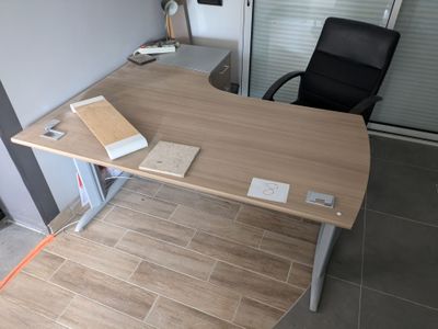 a desk with a chair and a book on it