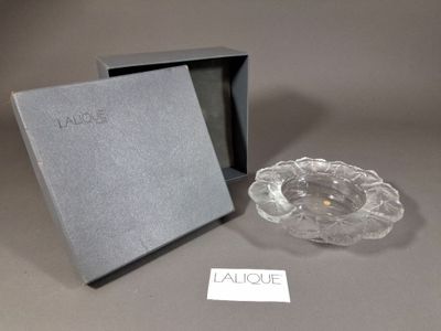 un cendrier en verre et une boîte posés sur une table