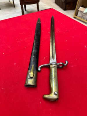 pair of antique brass - plated swords on a red cloth