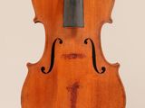 an old violin with a bow hanging from it ' s back