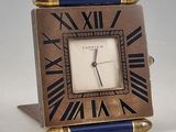 a small clock that is sitting on top of a table