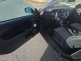 a black car with its door open on the street