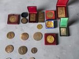 a lot of gold and silver coins in a red box