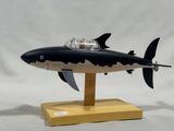 a toy shark with a man in a boat on top of it