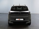 the back end of a grey mercedes suv parked in a room