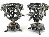 two silver vases with birds and flowers on them