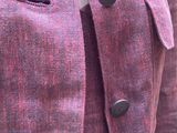 a close up of a red jacket with buttons on it