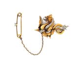 a close up of a brooch with a chain attached to it
