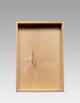 a close up of a wooden box with a hole in it