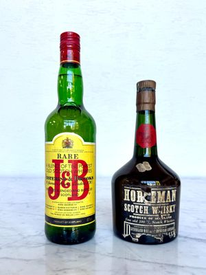 two bottles of liquor sitting next to each other on a table