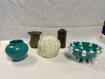 three vases sitting on a table with a white background