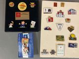 a lot of pins and magnets that are on the table