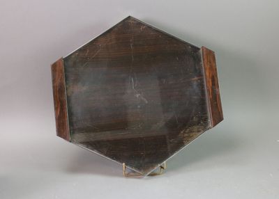 a small mirror that is on a stand on a table