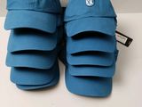 a pair of blue baseball caps sitting on top of a white table
