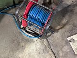 a hose that is attached to a reel on the ground