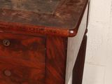 a wooden desk with a drawer on top of it