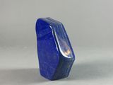 a close up of a blue stone on a white surface