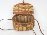 an image of a wicker bag with a handle on a white surface